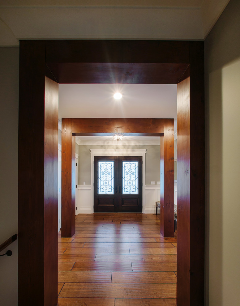 На фото: фойе среднего размера в стиле кантри с серыми стенами, паркетным полом среднего тона, двустворчатой входной дверью и входной дверью из темного дерева