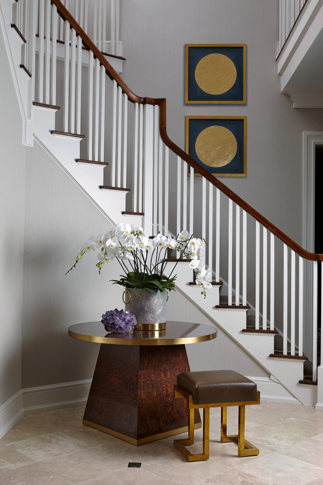 This is an example of a large traditional foyer in New York with grey walls.