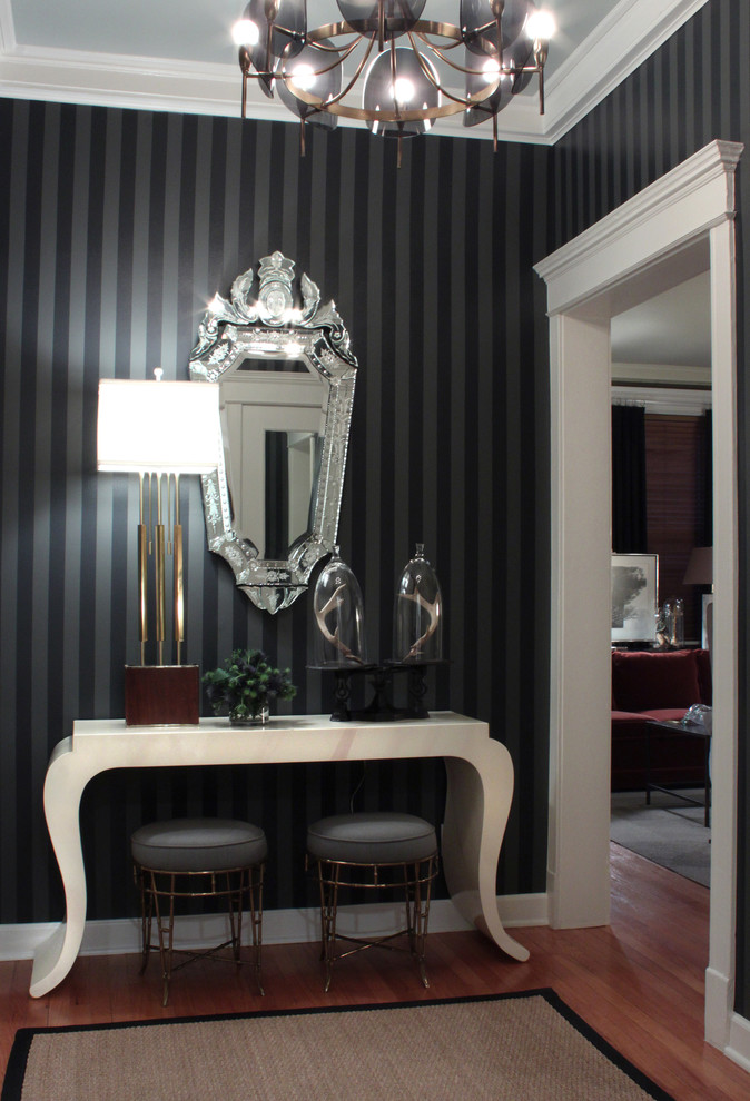 Inspiration for a transitional medium tone wood floor entryway remodel in Chicago with black walls