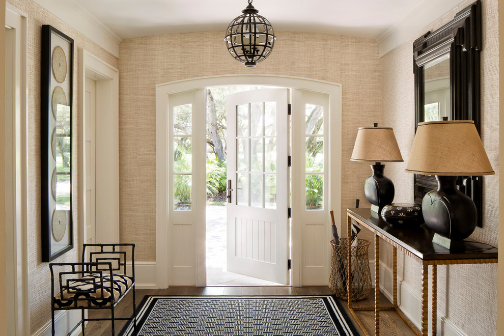 Entryway - large transitional medium tone wood floor entryway idea in Miami with beige walls and a white front door