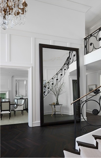 Foyer - huge transitional dark wood floor foyer idea in Detroit with white walls