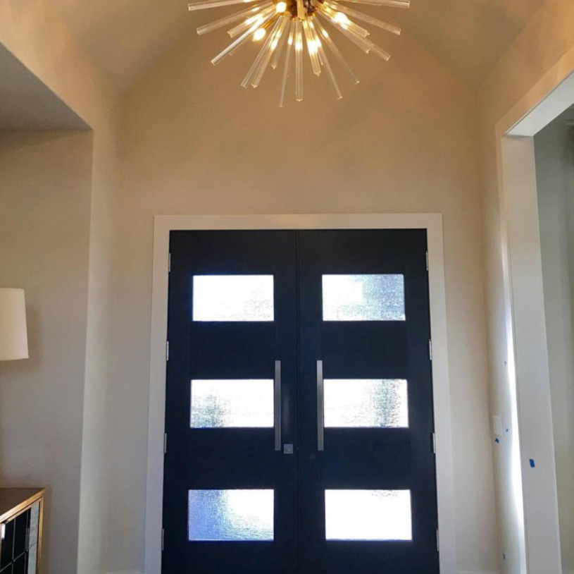 Photo of a medium sized contemporary front door in Little Rock with beige walls, dark hardwood flooring, a double front door and a black front door.