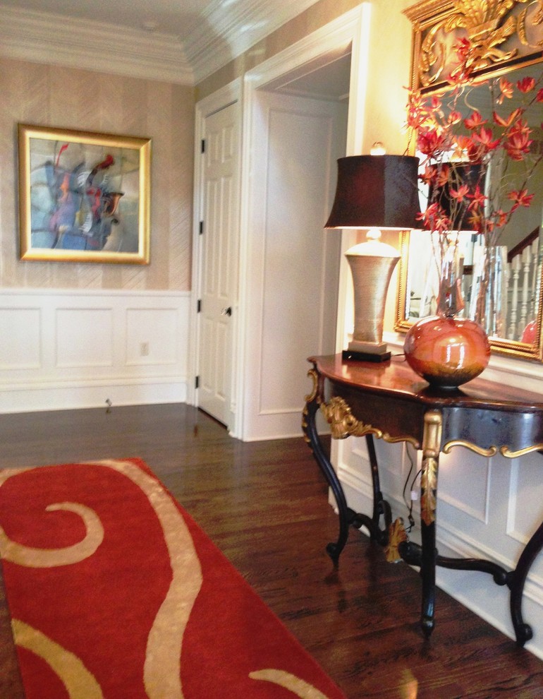 Inspiration for a mid-sized timeless medium tone wood floor entry hall remodel in Kansas City with beige walls