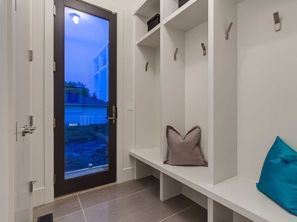 Small contemporary boot room in Calgary with white walls, porcelain flooring, a single front door and a glass front door.