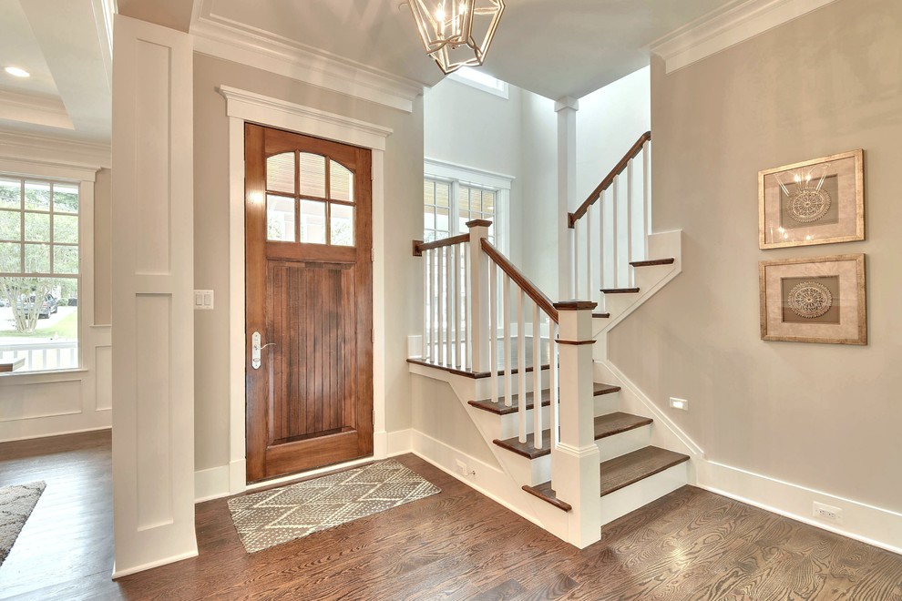 Design ideas for a medium sized classic foyer in DC Metro with brown walls, medium hardwood flooring, a single front door, a medium wood front door and brown floors.