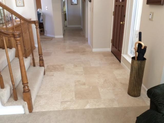 This is an example of a large classic foyer in Little Rock with beige walls, travertine flooring, a single front door and a dark wood front door.