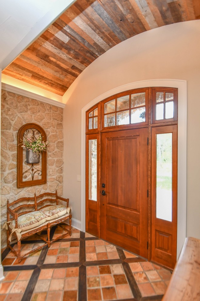 Inspiration for a medium sized farmhouse foyer in Milwaukee with beige walls, travertine flooring, a single front door, a medium wood front door and multi-coloured floors.
