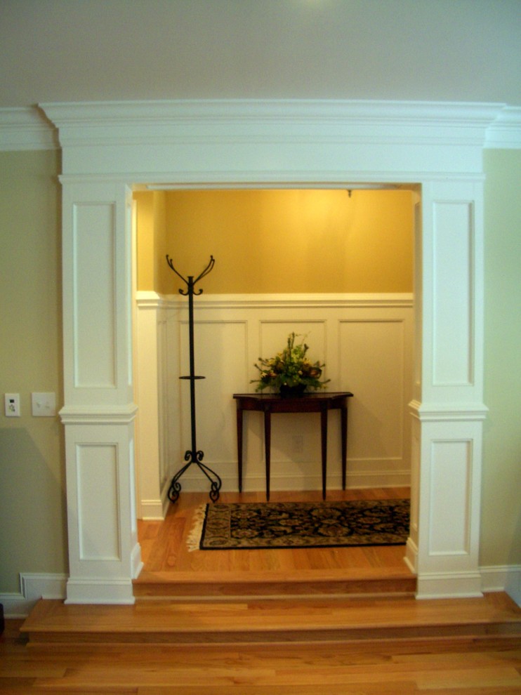 Inspiration for a large transitional medium tone wood floor entryway remodel in Other with beige walls and a dark wood front door
