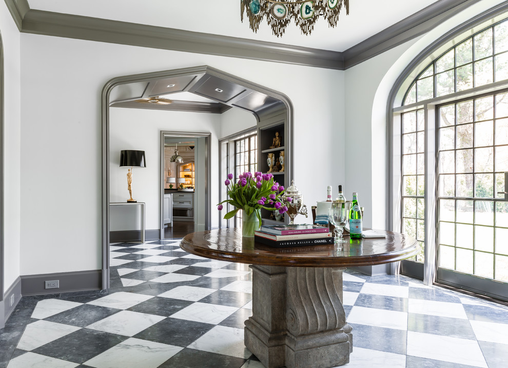 Foyer - eclectic marble floor foyer idea in New York with white walls