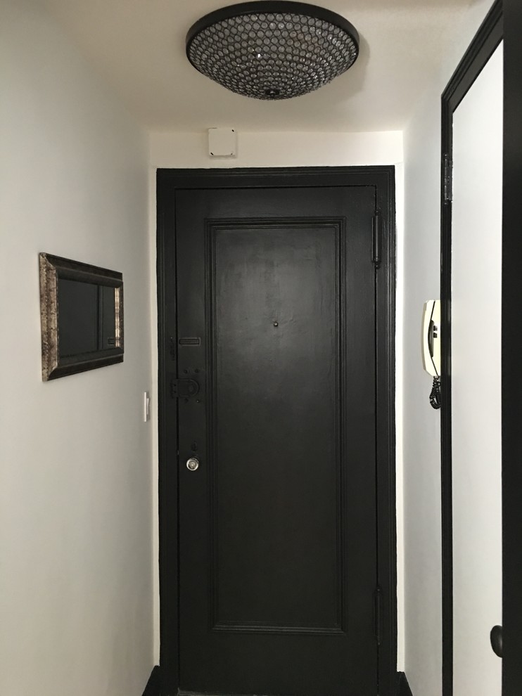 Пример оригинального дизайна: маленькая входная дверь в стиле фьюжн с белыми стенами, паркетным полом среднего тона, одностворчатой входной дверью, черной входной дверью и коричневым полом для на участке и в саду