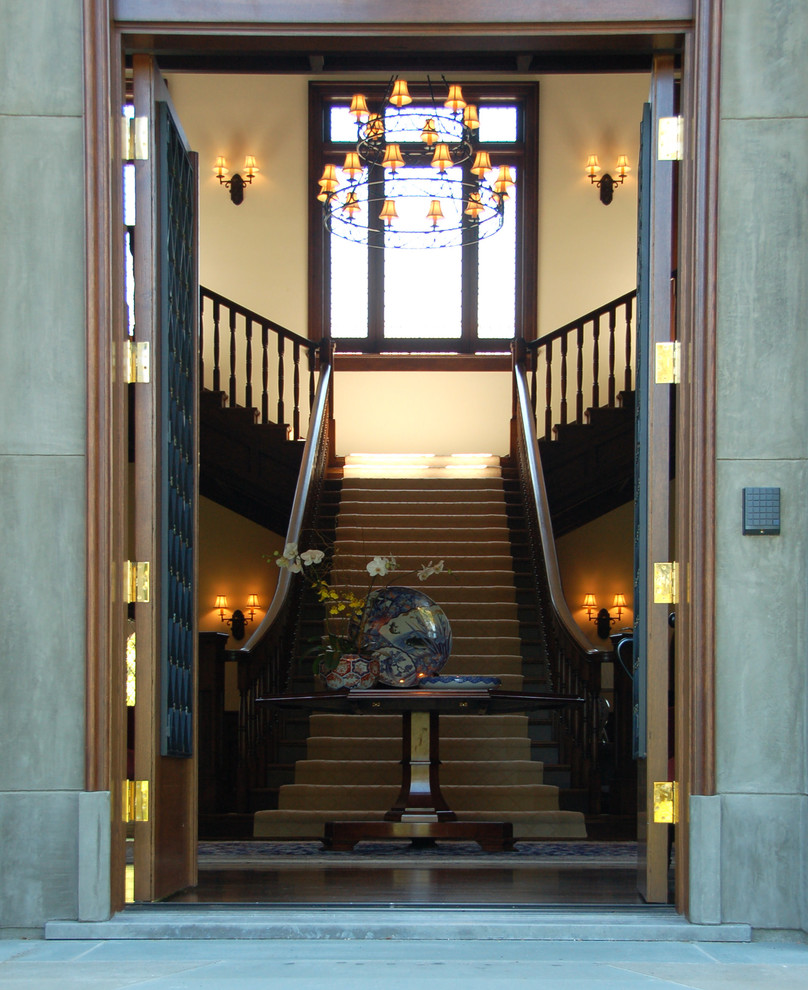 Entryway - huge victorian dark wood floor entryway idea in San Francisco with beige walls and a dark wood front door