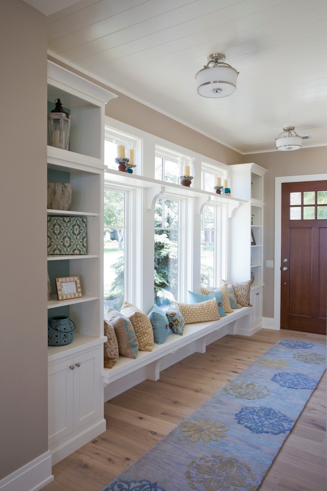Inspiration for a large nautical front door in Grand Rapids with blue walls, a single front door, a medium wood front door and light hardwood flooring.