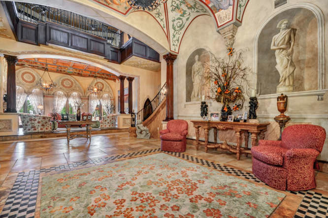 Inspiration for an expansive mediterranean foyer in Tampa with beige walls, travertine flooring, a double front door, a dark wood front door and yellow floors.