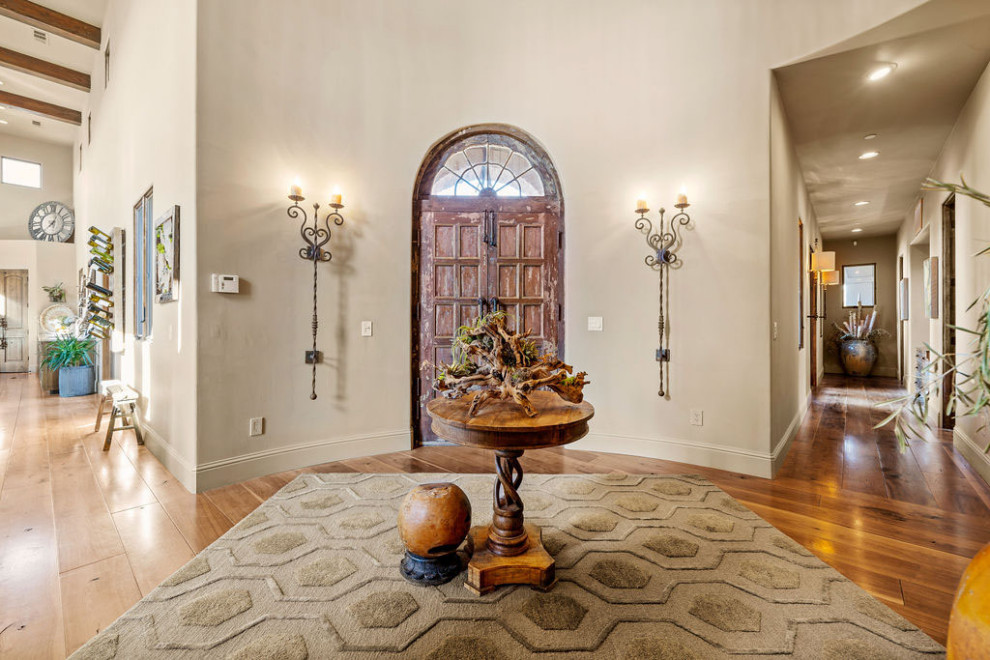 Mid-sized tuscan dark wood floor and brown floor entryway photo in San Francisco with beige walls and a light wood front door