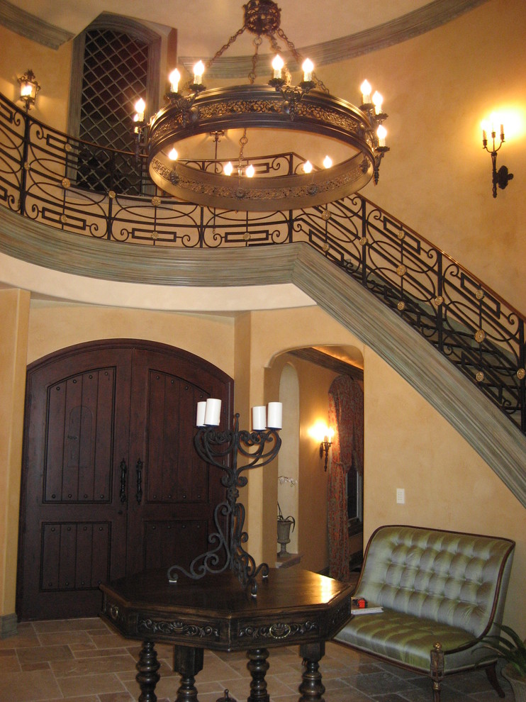 This is an example of a mediterranean foyer in Chicago with beige walls, a double front door and a dark wood front door.