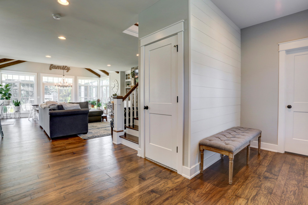 Inspiration for a large farmhouse front door with grey walls, medium hardwood flooring and brown floors.