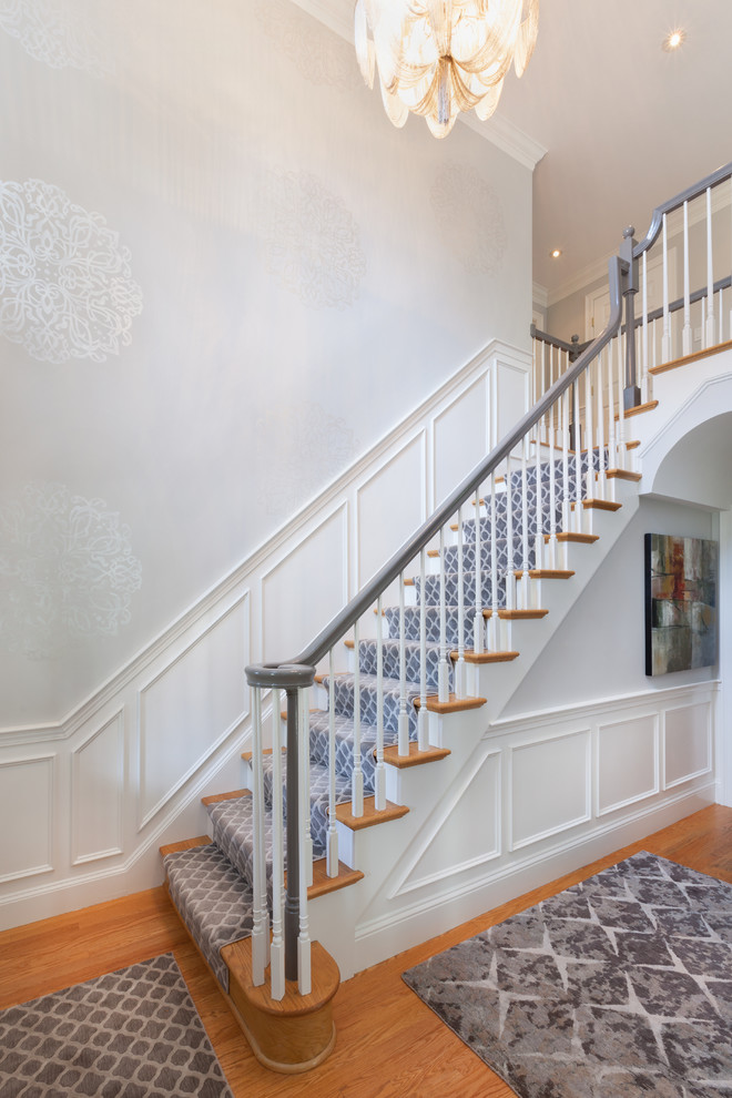 Example of a large transitional light wood floor foyer design in Boston with gray walls