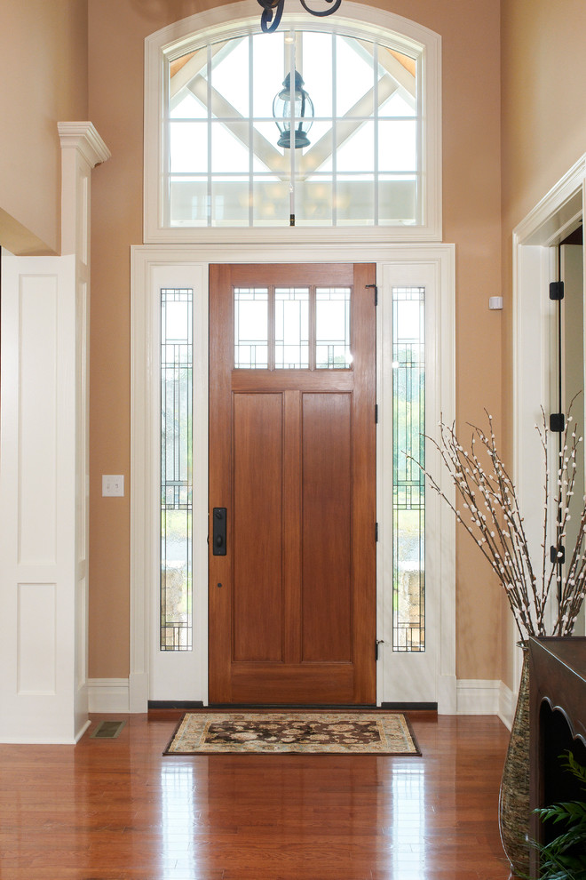 Design ideas for a medium sized traditional foyer in Other with beige walls, medium hardwood flooring, a single front door and a medium wood front door.