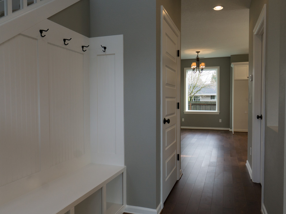 Inspiration for a small timeless medium tone wood floor entryway remodel in Portland with beige walls and a medium wood front door