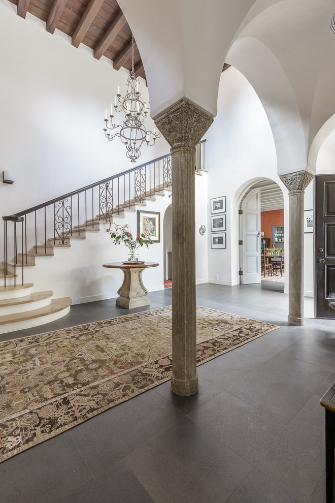 Photo of a large mediterranean hallway in San Francisco with white walls, concrete flooring and grey floors.