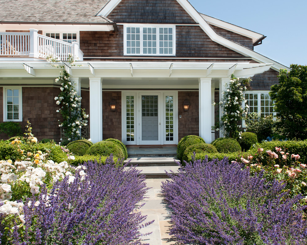 Victorian porch in Bridgeport with a single front door, a glass front door, brown walls and slate flooring.