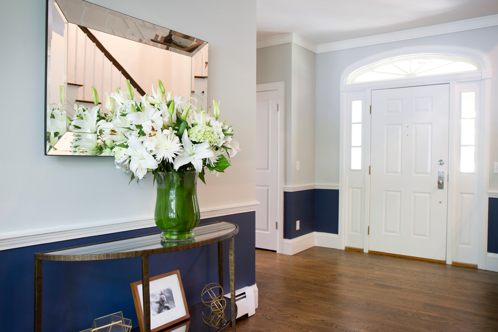 Inspiration for a medium sized classic hallway in New York with grey walls, dark hardwood flooring, a single front door and a white front door.