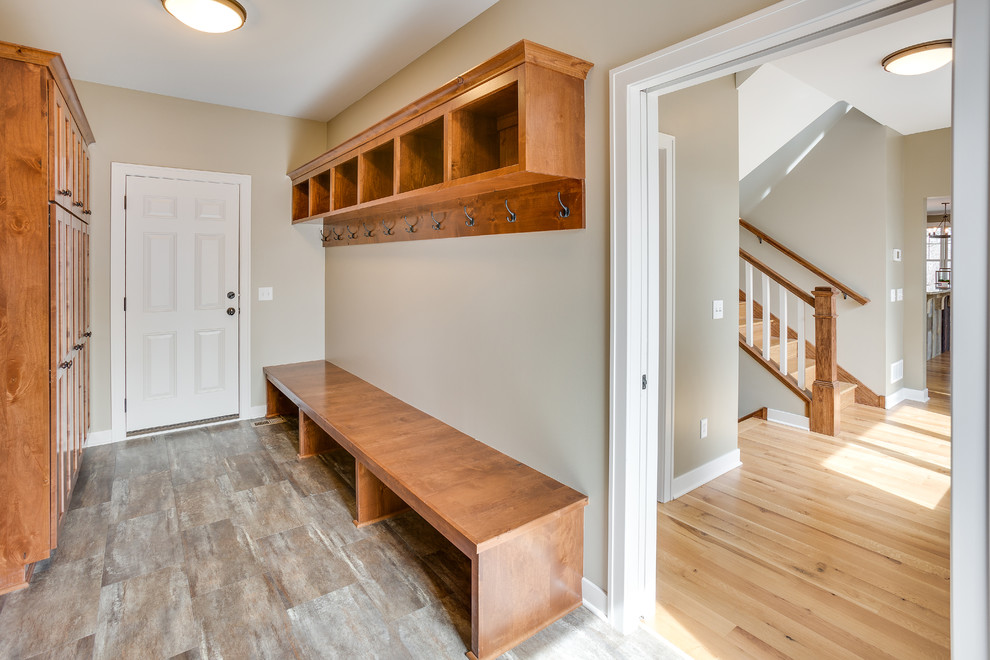 Photo of a medium sized traditional boot room in Minneapolis with beige walls, porcelain flooring, a single front door, a white front door and feature lighting.