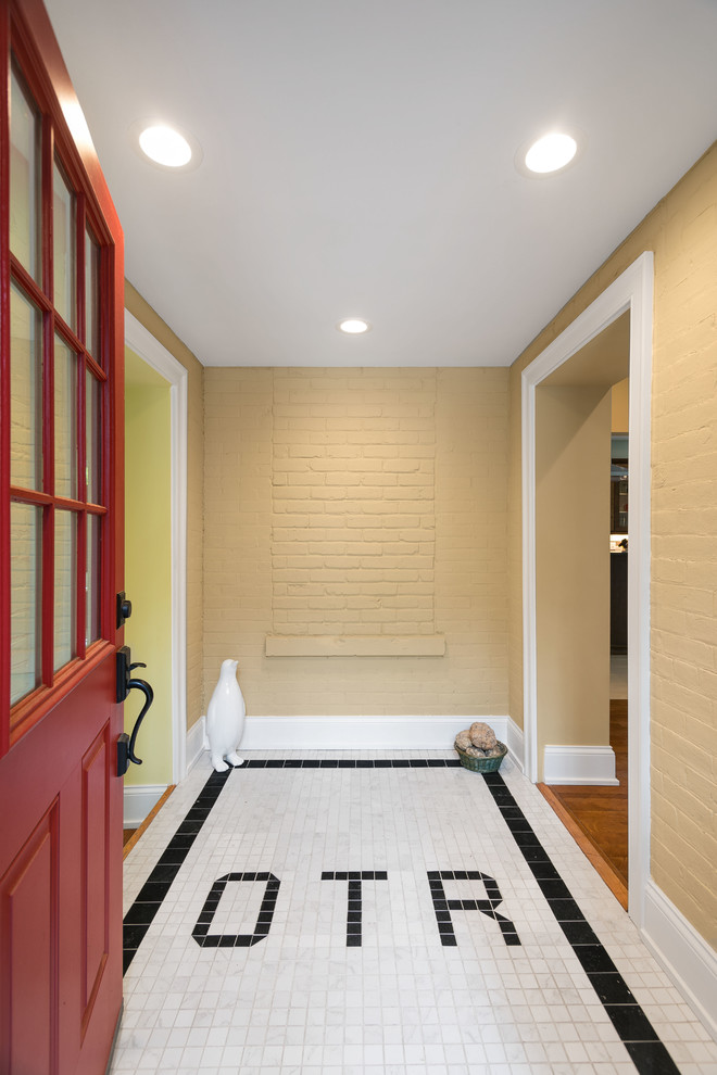 Photo of a medium sized eclectic foyer in Cincinnati with yellow walls, porcelain flooring, a single front door and a red front door.