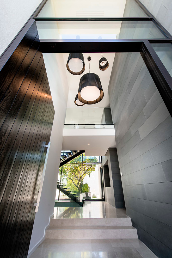 This is an example of a large contemporary foyer in Perth with a pivot front door and a dark wood front door.