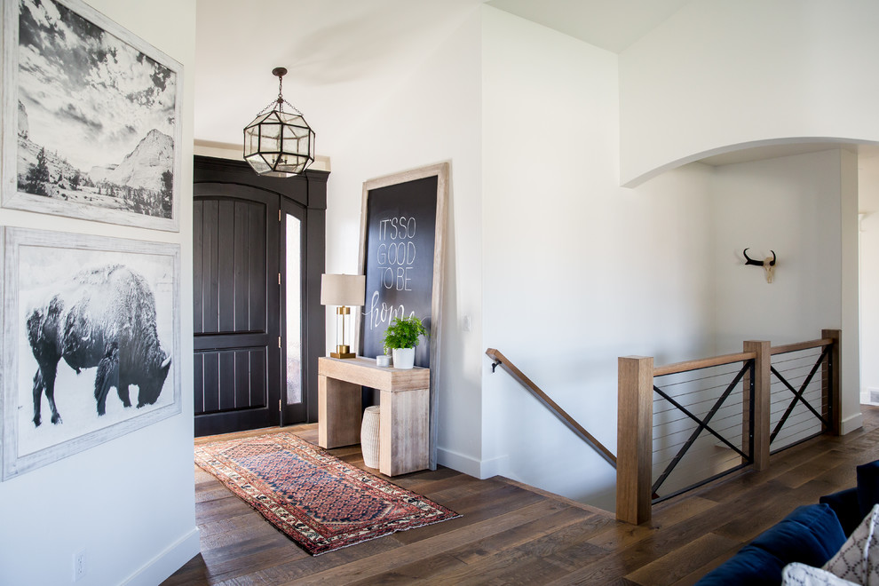Small transitional medium tone wood floor entryway photo in Salt Lake City with white walls and a black front door