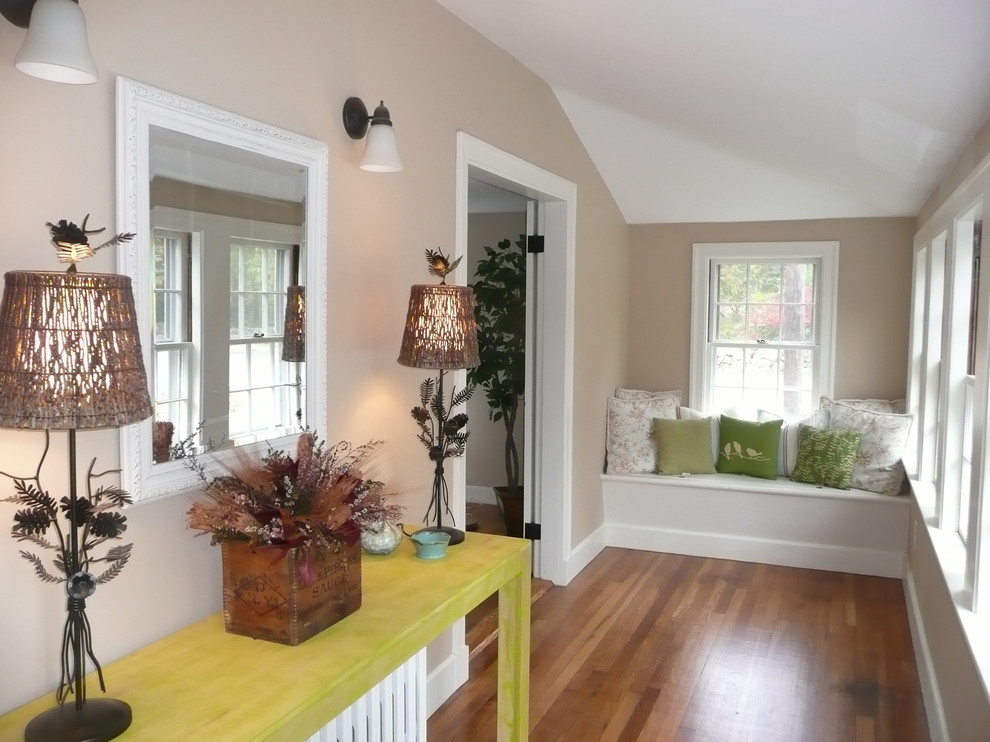 Mid-sized elegant medium tone wood floor and brown floor mudroom photo in Boston with beige walls