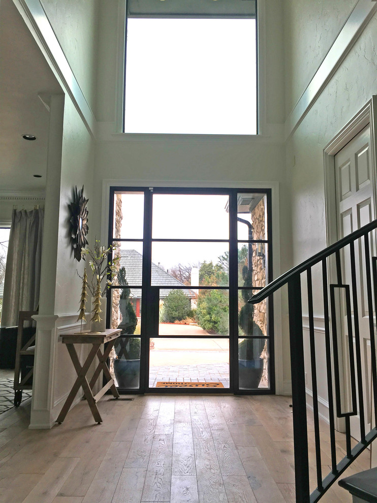 Foto di una porta d'ingresso chic di medie dimensioni con pareti beige, pavimento in legno massello medio, una porta singola, una porta in vetro e pavimento marrone