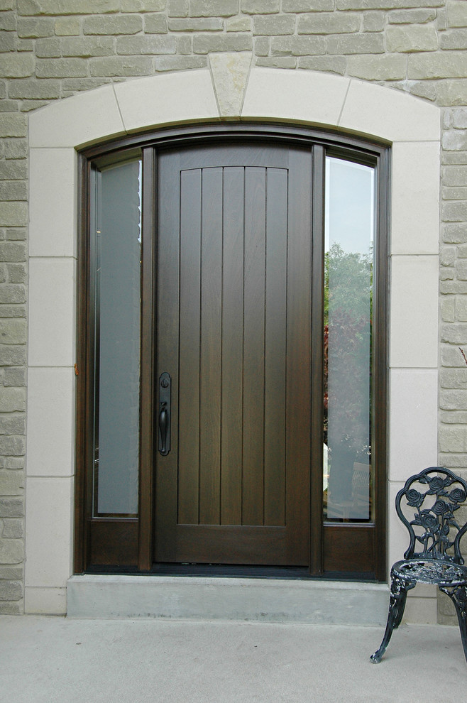 Example of a mid-sized classic entryway design in Toronto with a dark wood front door