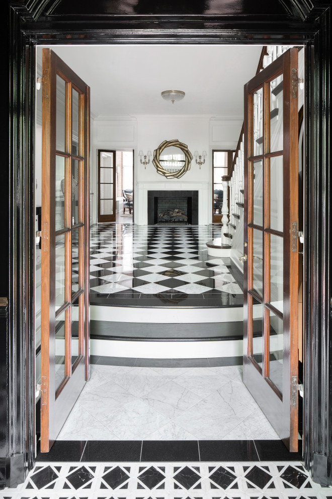 Elegant marble floor and multicolored floor entryway photo in St Louis with multicolored walls and a dark wood front door