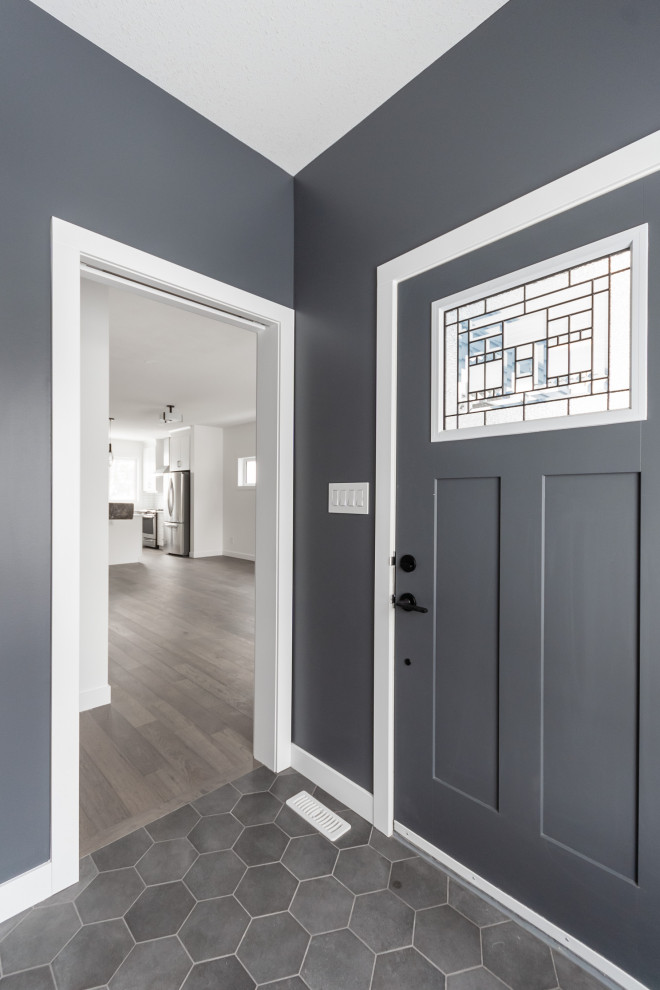 Inspiration for a medium sized modern hallway in Other with grey walls, a single front door, a grey front door and grey floors.