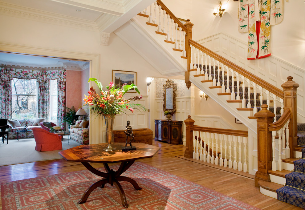 Design ideas for a large traditional foyer with beige walls, light hardwood flooring and beige floors.
