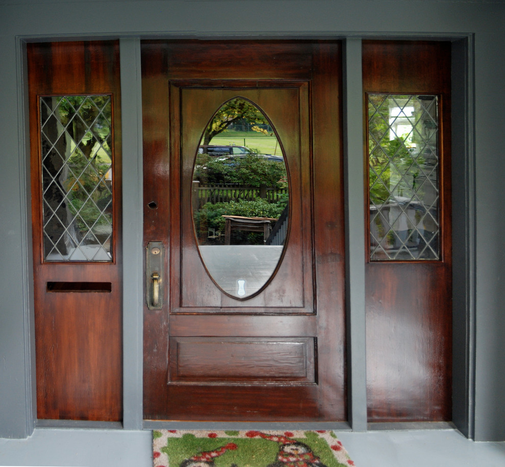 Foto di una porta d'ingresso minimalista di medie dimensioni con pareti grigie, pavimento in legno verniciato, una porta singola e una porta in legno scuro