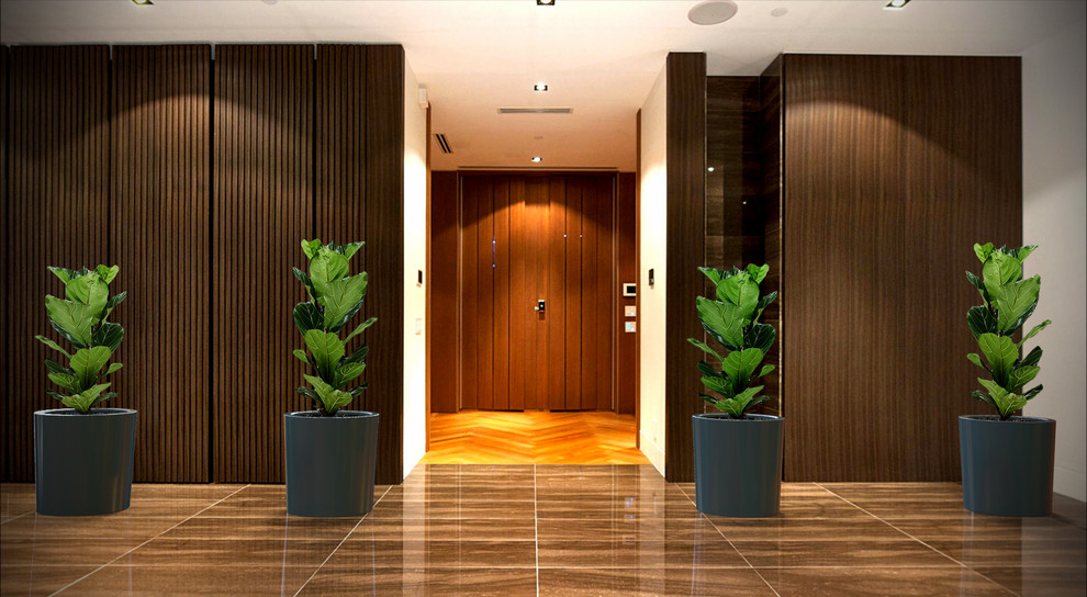 Entryway - large contemporary marble floor entryway idea in Toronto with brown walls and a dark wood front door
