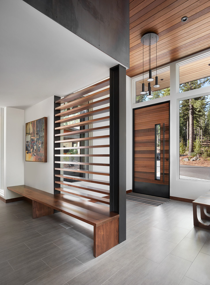 Huge trendy porcelain tile and gray floor entryway photo in San Francisco with a medium wood front door and white walls