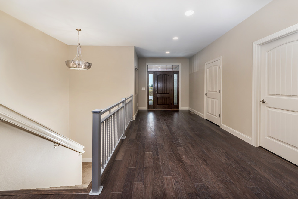 Large elegant dark wood floor entryway photo in Other with beige walls and a dark wood front door