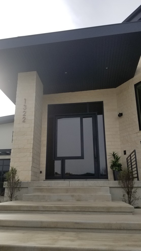 Example of a large trendy entryway design in Phoenix with a glass front door