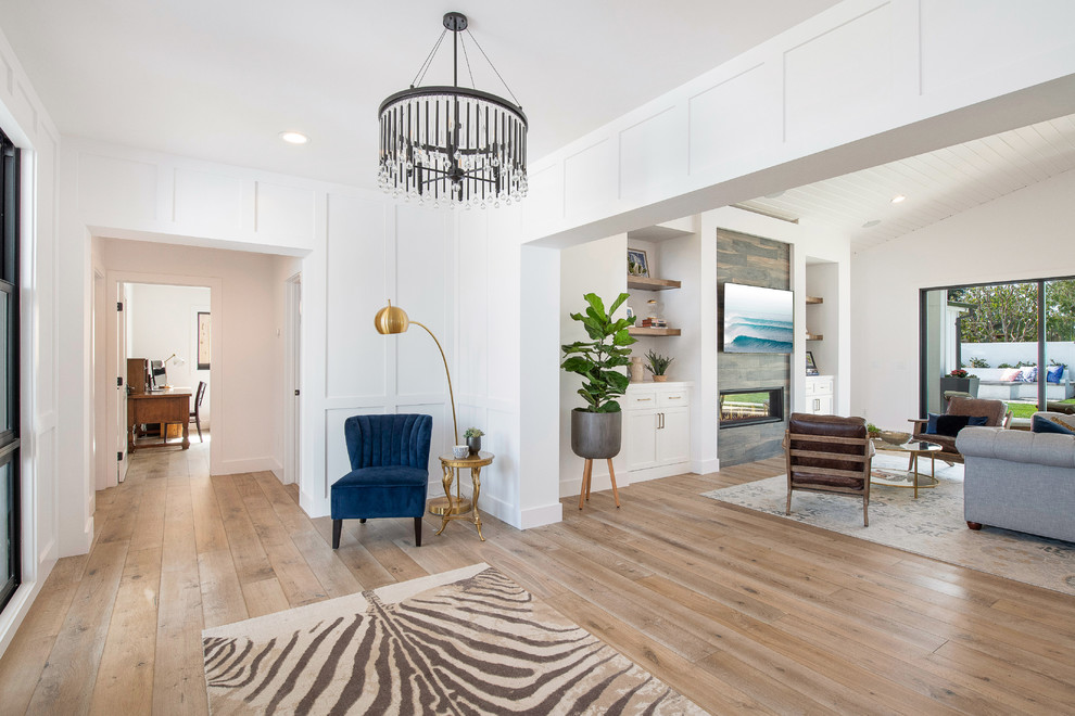 Large rural front door in Orange County with white walls, medium hardwood flooring, a stable front door, a brown front door, brown floors and feature lighting.