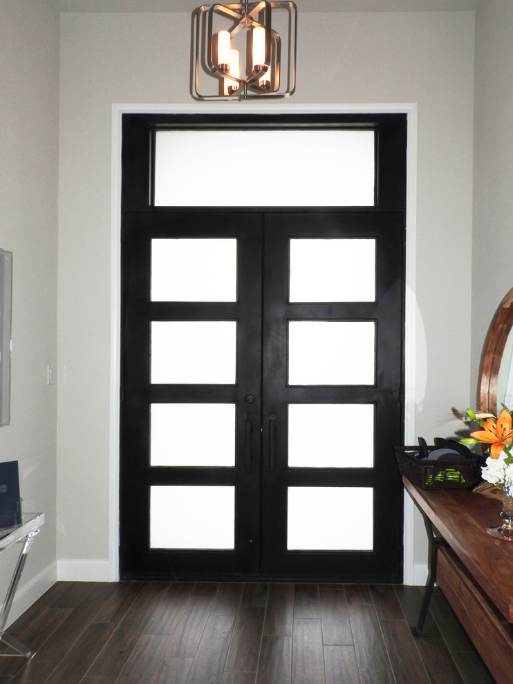 Example of a trendy entryway design in Austin with a metal front door