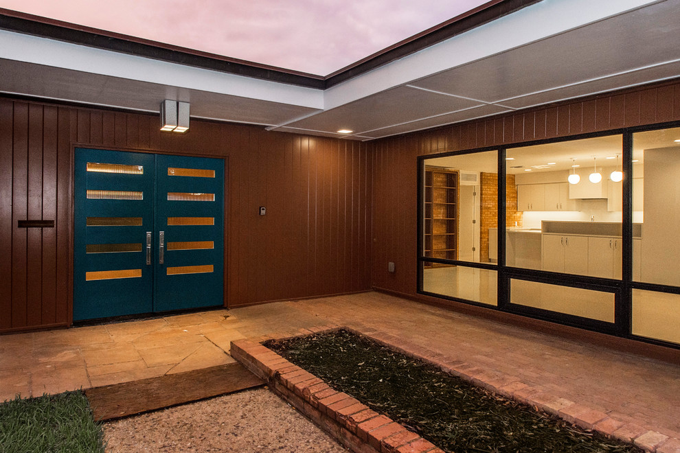 Photo of a midcentury front door in Dallas with brown walls, a double front door and a blue front door.