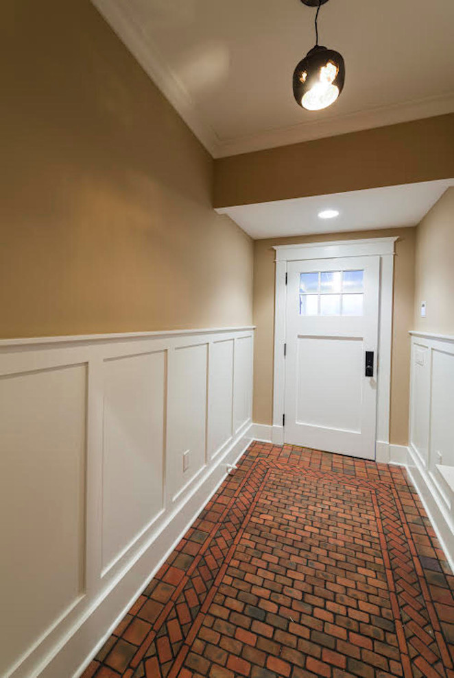 Inspiration for a large transitional brick floor entryway remodel in Philadelphia with beige walls and a white front door