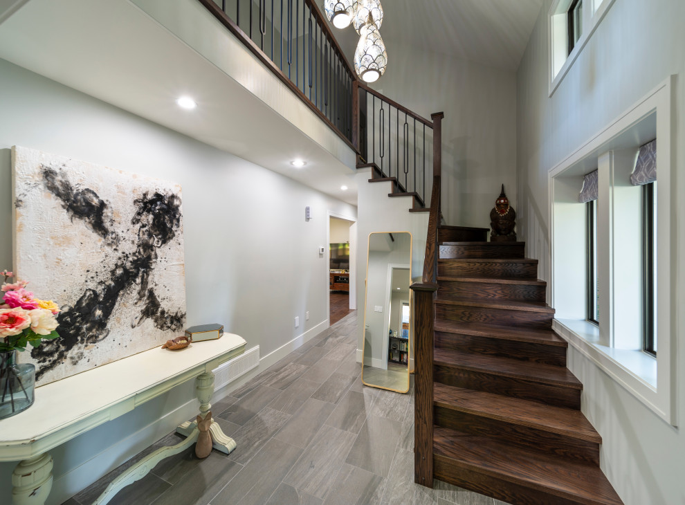 Photo of a medium sized contemporary foyer in Vancouver with grey walls, ceramic flooring, a single front door, a brown front door and grey floors.