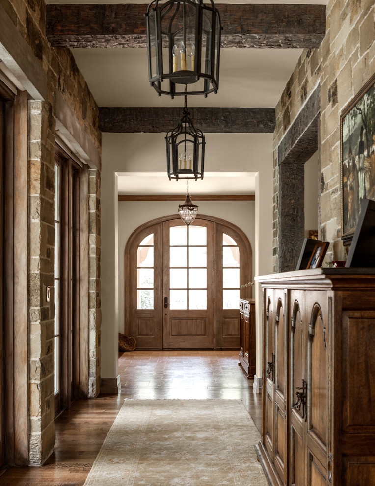 Mediterranean hallway in Dallas with white walls and a single front door.