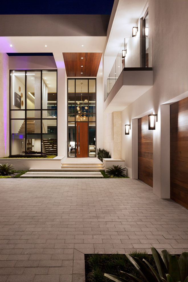 Expansive modern front door in Miami with white walls, a single front door and a medium wood front door.