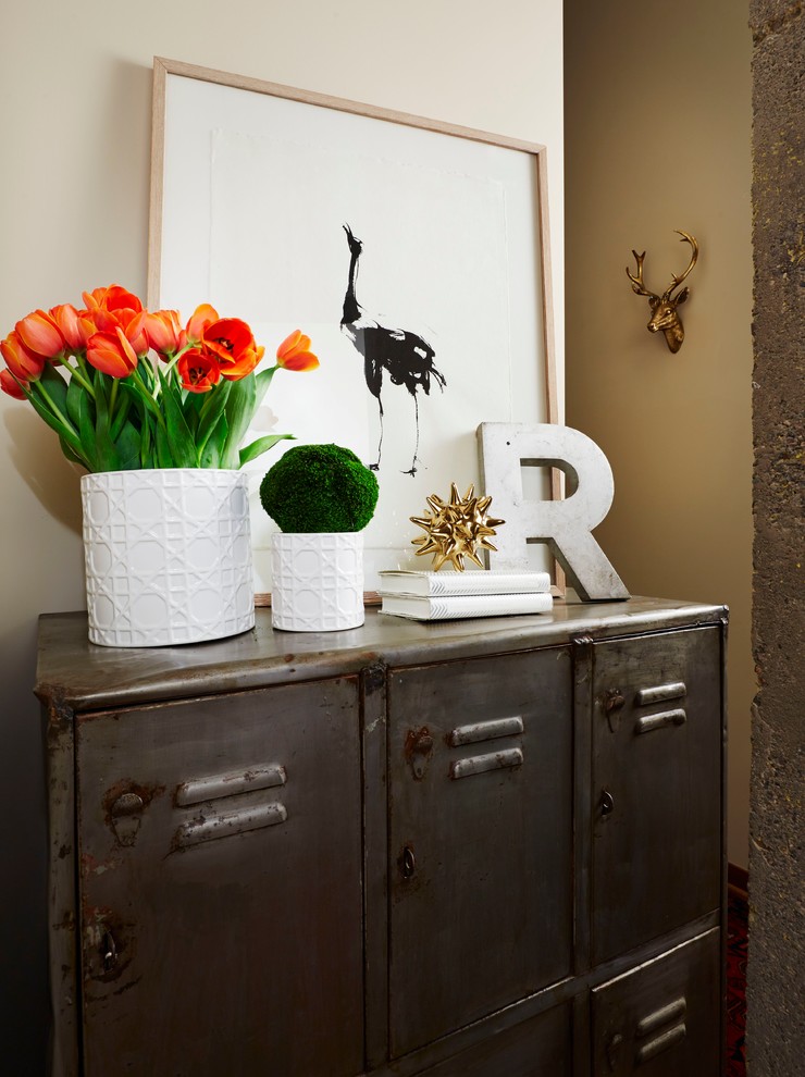 Inspiration for a small industrial medium tone wood floor entryway remodel in Minneapolis with beige walls and a dark wood front door