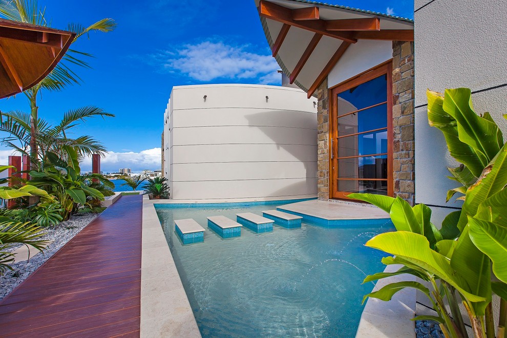 Pivot front door - tropical pivot front door idea in Sunshine Coast with a glass front door